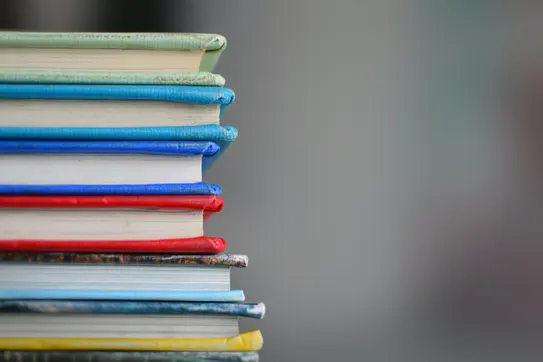 Photo of a stack of books, by Kimberly Farmer on Unsplash