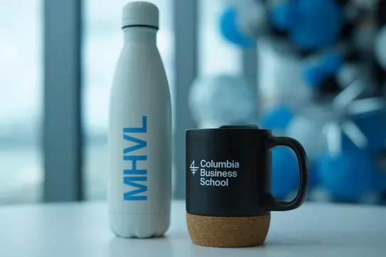 A CBS-branded water bottle sits next to a CBS-branded mug on a tabletop