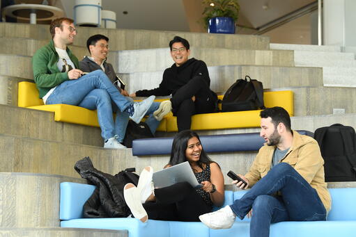 Students casually chatting in Kravis Hall