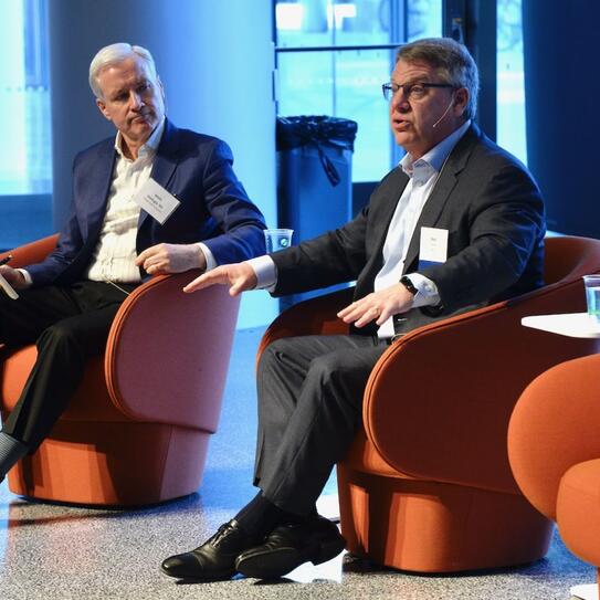 Moderator Mark Gallogly ’86, left, cofounder of Three Cairns Group, and Rich Lesser, global chair of the Boston Consulting Group, speak at the 2022 Climate Business & Investment Conference